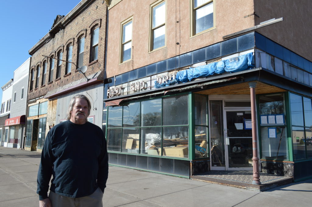 Walter Haugen stands outside the former East End Drug store his father operated for almost 70 years in Superior. The set of buildings on East Fifth Street are planned for demolition this spring.