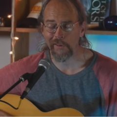 Charlie Parr on a blue chair