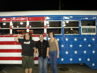 Barrett, Ca-Chee and LumpyG in front of a patriotic school bus