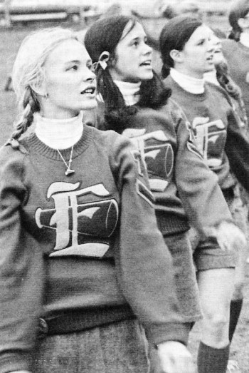 The cheerleaders put total effort into creating school spirit at a football game