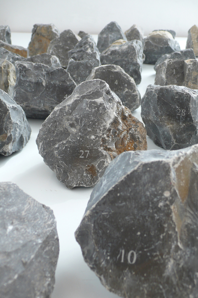 Situation, 2011. 46 numbered and engraved stones. A permanent installation and interactive project within the studio spaces of the Akademie Schloss Solitude in Stuttgart, Germany. 46 stones were engraved with the corresponding number of the studio in which they were placed and left to be used by the future residents living and working in the spaces. Along with each stone, a text about the project was hung in every studio to inform and invite the resident to contribute to the project with documentation of how the stone is integrated into their studio space. The on-going collection of documentation can be seen at situation.svbtle.com