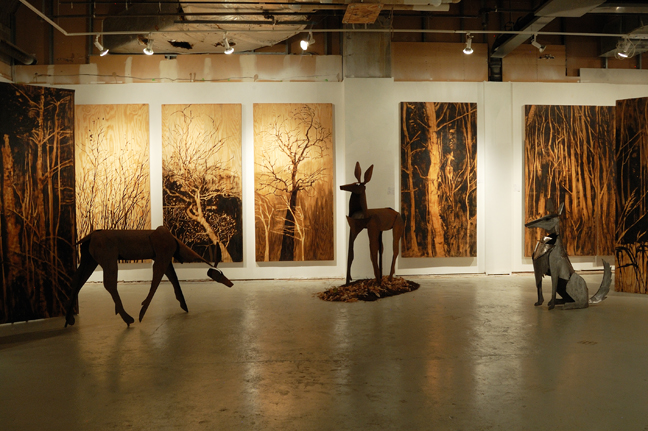 This image is from my 2014 show in Minneapolis at Gallery 13. It was called “Living Room” (try out all the different ways of reading that--) and featured my 8’x4’ plywood-and-tar panels painted with forest imagery and my life-sized steel deer and wolves, from the body of work called Pack and Herd. 