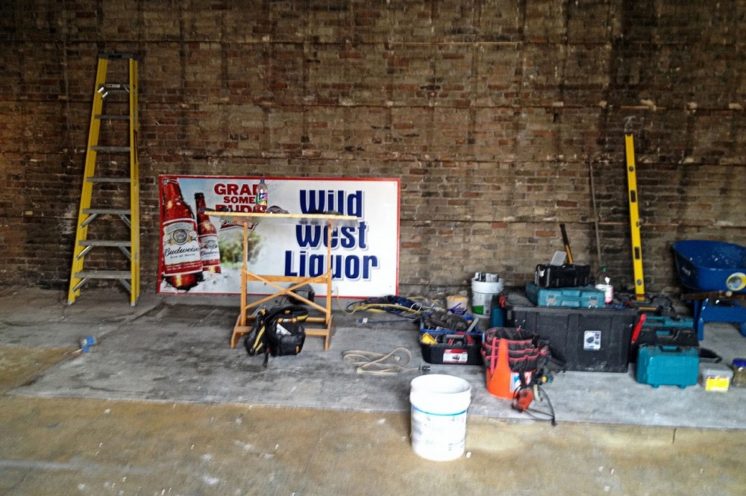 A sign from the former Wild West Liquor rests on the floor while the building was gutted in July.